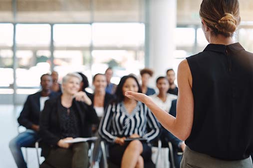a woman speaking to a group of people