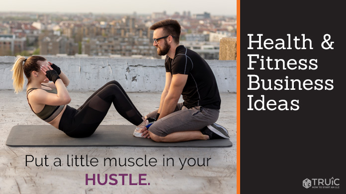 A woman doing sit-ups while a man holds her feet in place.