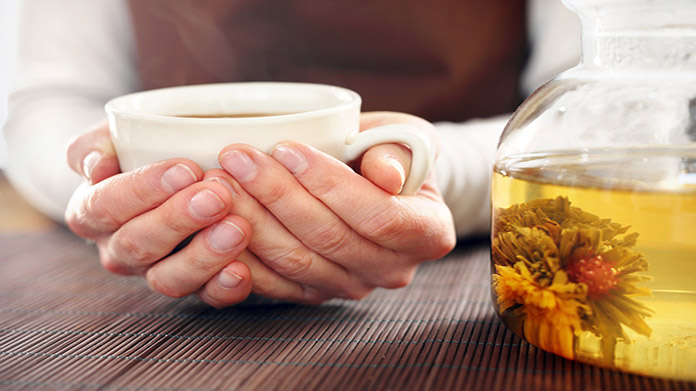 a person holding a cup of tea