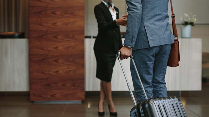 A guest checking in with a hotel employee.